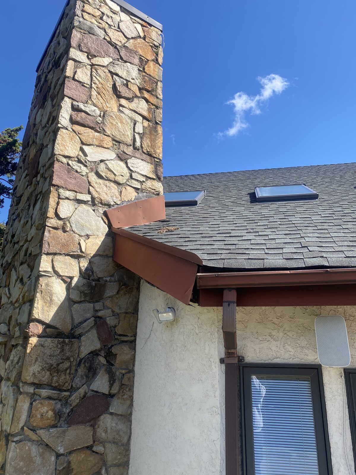 Restored stone chimney with new copper flashing